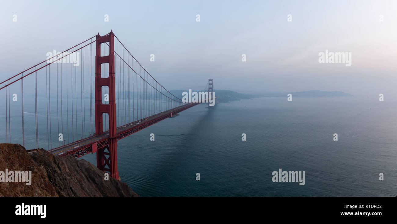 Beautiful panoramic view of Golden Gate Bridge during a hazy sunset. Taken in San Francisco, California, United States. Stock Photo