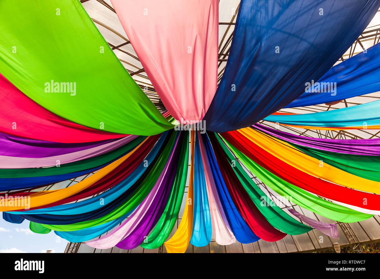 Fabrics Of Various Colors Hanging From A Ceiling Stock Photo