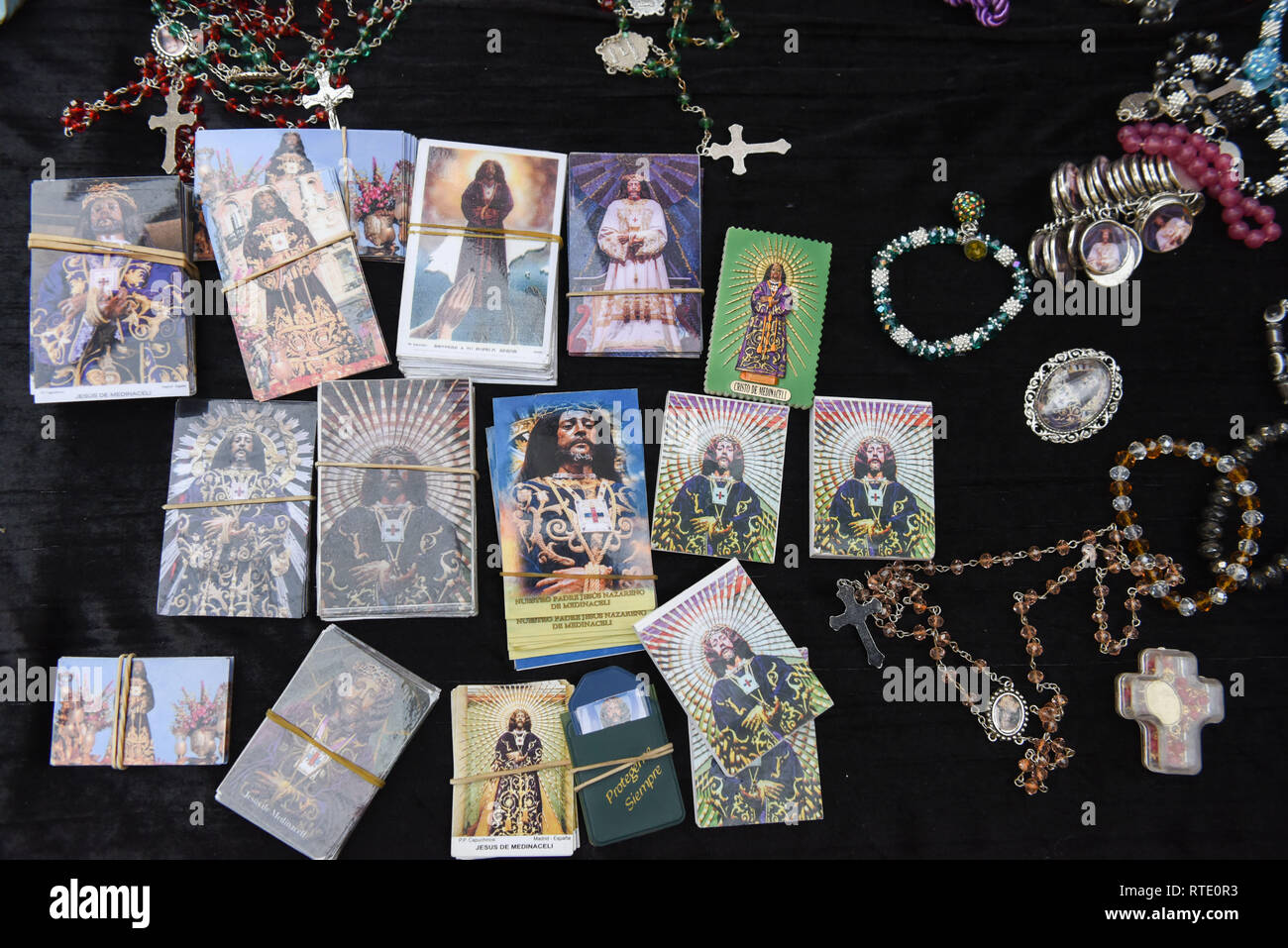 Calendars and magnets with the image of 'Cristo de Medinaceli' are seen displayed next to 'Jesús de Medinaceli' church in Madrid. Thousands of Catholics from various countries gathered close to the  'Jesús de Medinaceli' church in Madrid on the first Friday of March, Friday of Lent,  to kiss the right foot of a 17th-century wooden image of Christ, known as Christ of Medinaceli. Pilgrims make three wishes to Jesus, of which he is said to grant one. Stock Photo