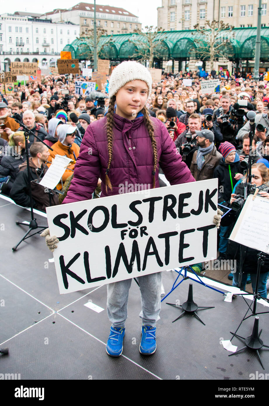 Hamburg, Germany. 01st Mar, 2019. Greta Thunberg, climate activist, stands with a banner on a stage during a rally on the town hall market. The young Swedish woman has come to Germany for the first time for a school strike for more climate protection. Credit: Daniel Bockwoldt/dpa/Alamy Live News Stock Photo