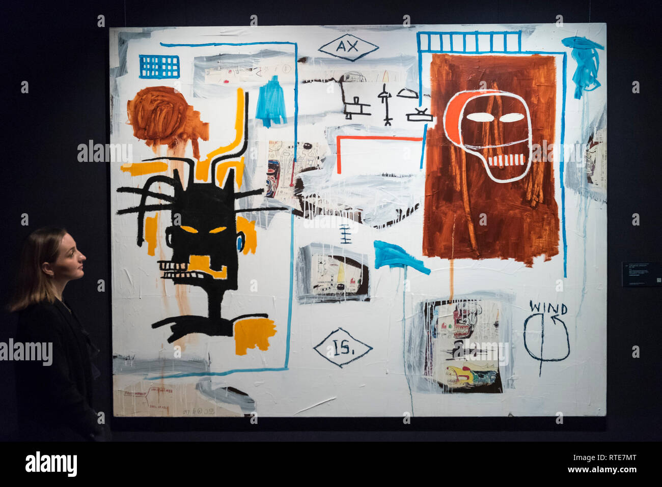 London, UK.  1 March 2019. A staff member views ''Apex'' by Jean-Michel Basquiat, (Est. £5-7m). Preview of Sotheby's Contemporary Art Sale in their New Bond Street galleries.  Works by artists including Tracey Emin, Jenny Saville, Jean-Michel Basquiat and Andy Warhol will be offered for auction on 5 March 2019.   Credit: Stephen Chung / Alamy Live News Stock Photo