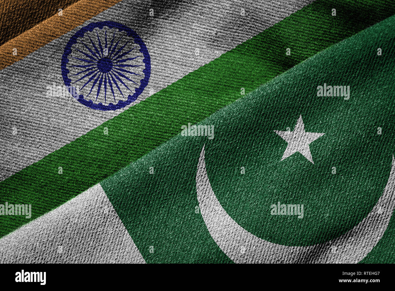 Overlapping grunge flags of India and Pakistan,  highlighting the ongoing political tension and conflict between the two neighboring countries since 1 Stock Photo