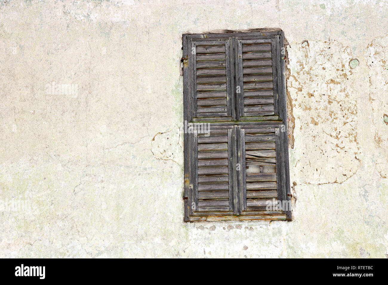 window of old house with wooden shutters closed Stock Photo
