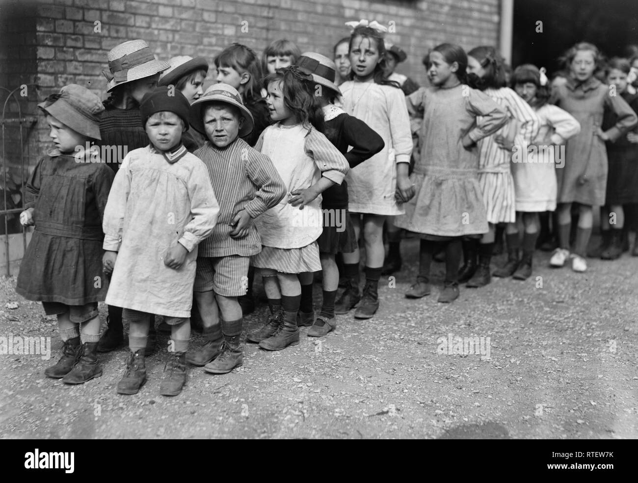 Group of French school children in charge of a French sister about to start for the barraquement at the Porte de Versailles, outside the Paris fortifications, where the American Red Cross co-operates with the 'Oeuvre de la Chaussee du Maine' in helping to establish the health of delicate children by means of outdoor play and work in individual garden plots. June 1918 Stock Photo