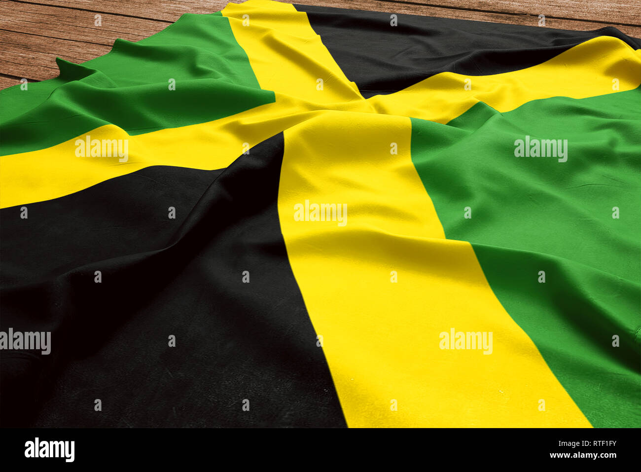 Flag of Jamaica on a wooden desk background. Silk Jamaican flag top view. Stock Photo