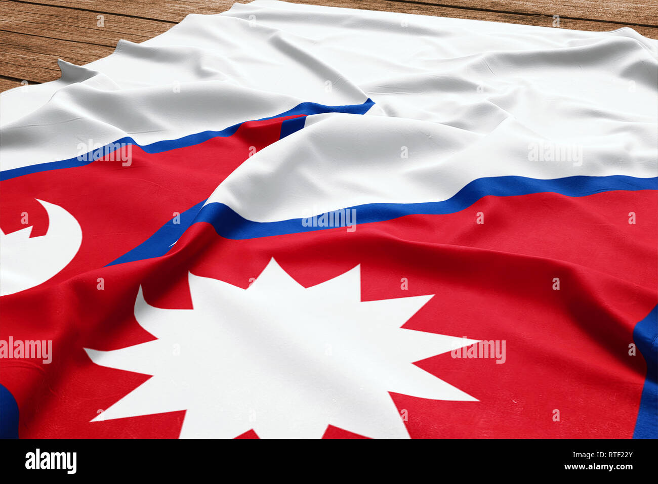 Flag of Nepal on a wooden desk background. Silk Nepalese flag top view