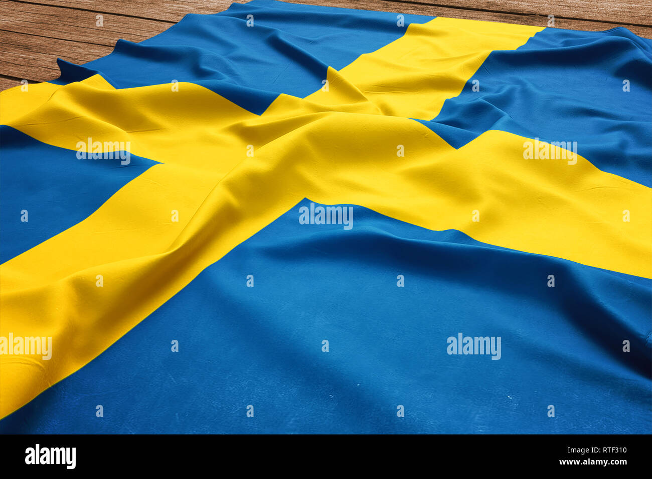 Flag of Sweden on a wooden desk background. Silk Swedish flag top view. Stock Photo
