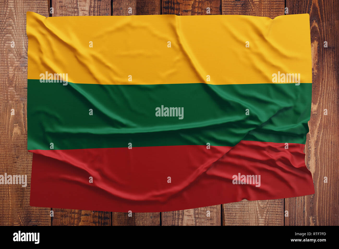 Flag of Lithuania on a wooden table background. Wrinkled Lithuanian flag  top view Stock Photo - Alamy