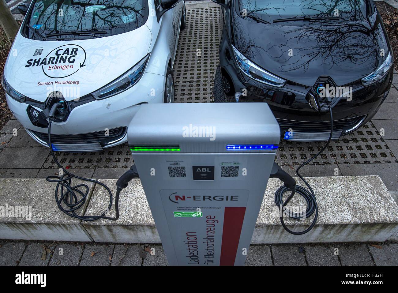 Two electric cars at a charging station on a parking lot, Bavaria, Germany Stock Photo