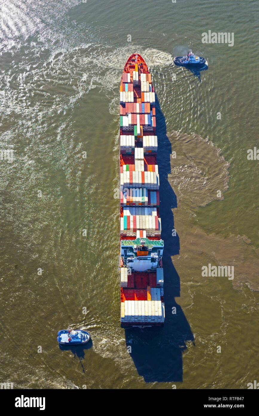 Aerial view, tugboat manoeuvring container ship, Hamburg, Germany Stock Photo