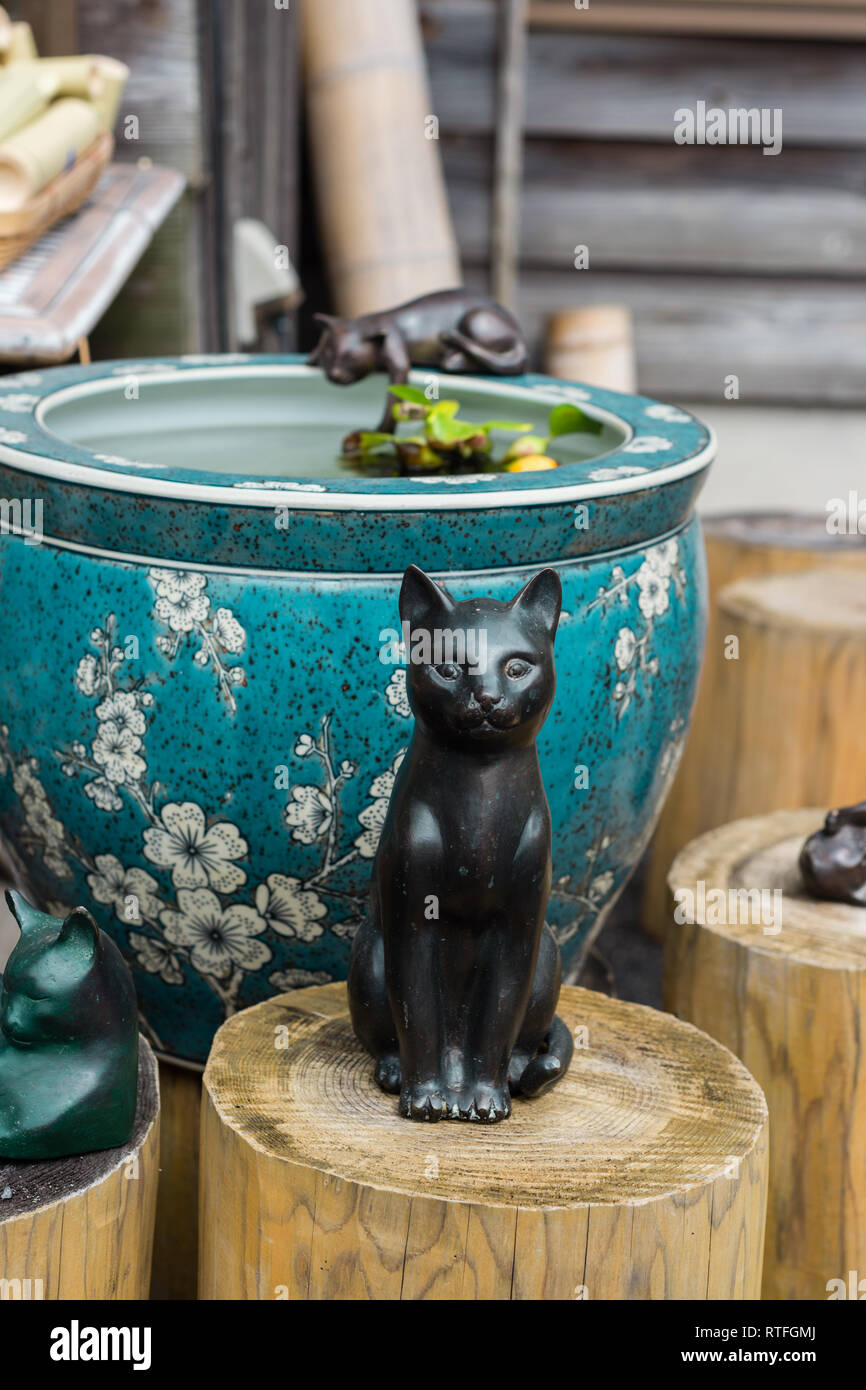 ceramic cat ornament in garden Stock Photo Alamy