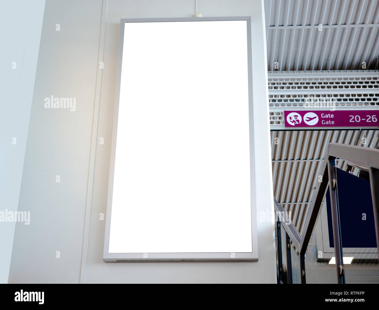 White blank empty signboard, billboard, mock-up at the airport terminal, gate, mock up of poster, media template ads display for any promotions. Stock Photo