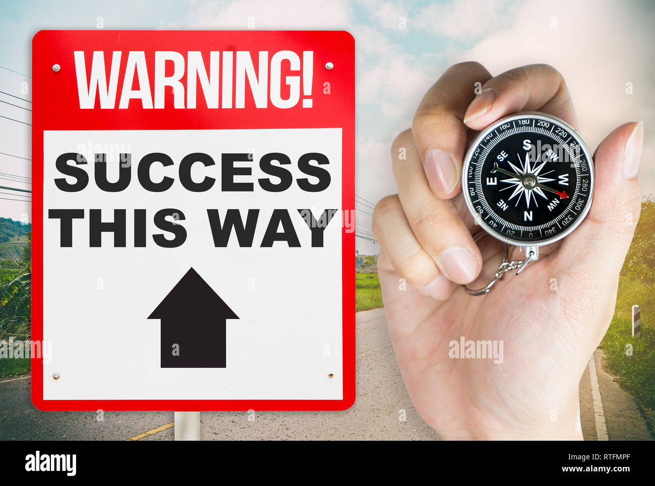 Holding compass for the way to success warning concept signage Stock