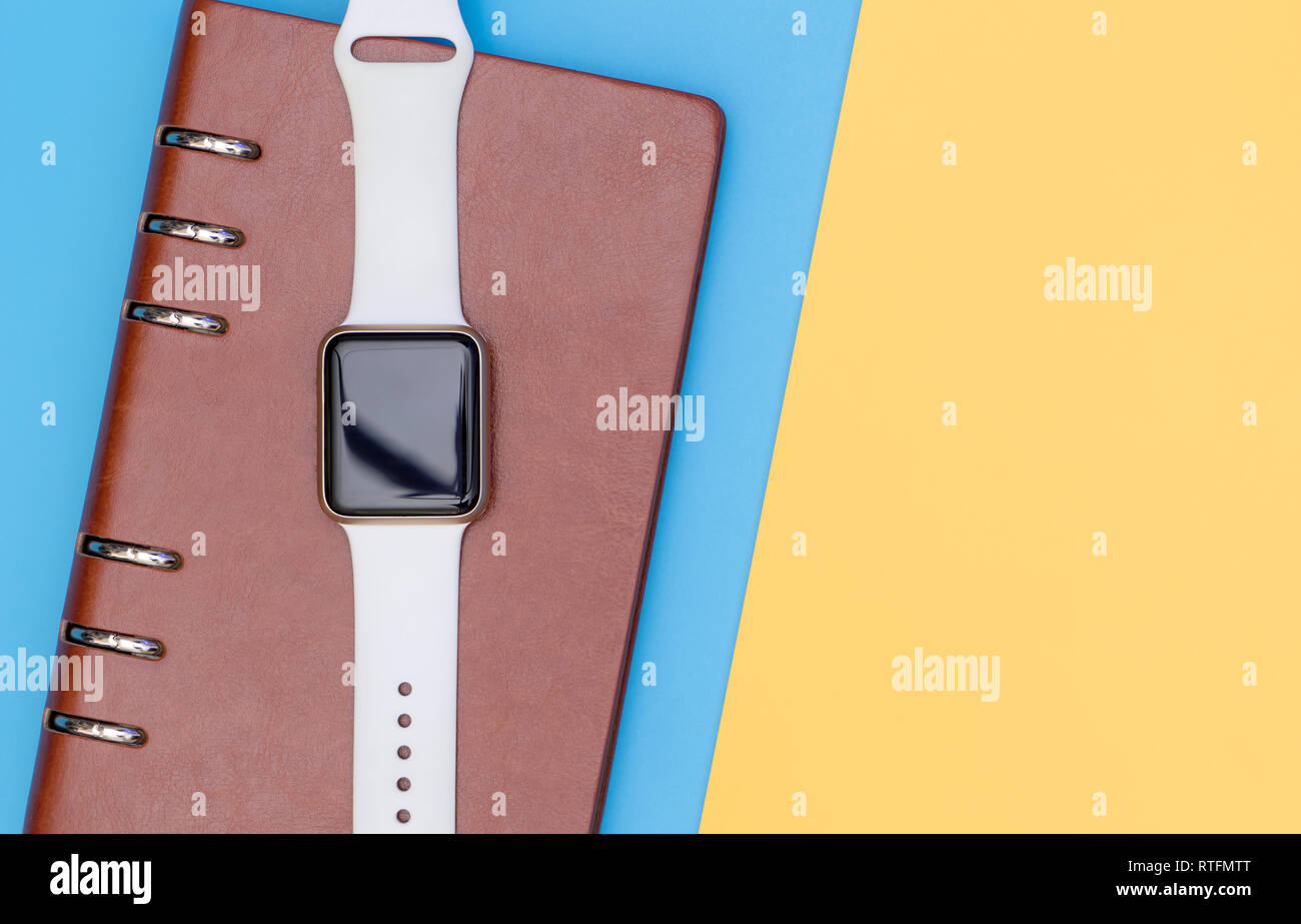 Smart watch on notebook for organize concept with blue yellow Stock ...