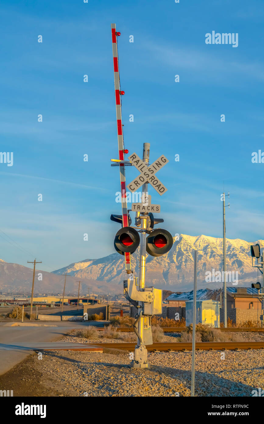 Two Tracks Railroad Crossing Sign Beside A Railway Two Tracks Railroad Crossing Sign With Barrier And Red Lights Buildings Mountain And Sky Can Be Stock Photo Alamy Two Tracks Railroad Crossing Sign Beside A Railway Two Tracks Railroad Crossing Sign With Barrier And Red Lights Buildings Mountain And Sky Can Be Stock Photo Alamy