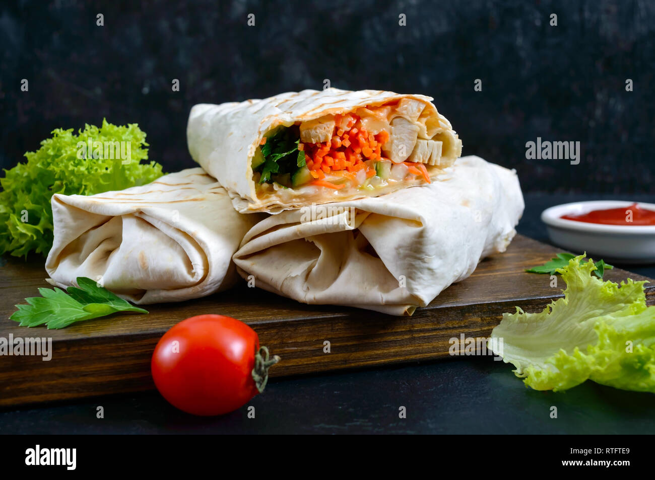 Delicious shawarma sandwich on a black background. Burritos wraps with