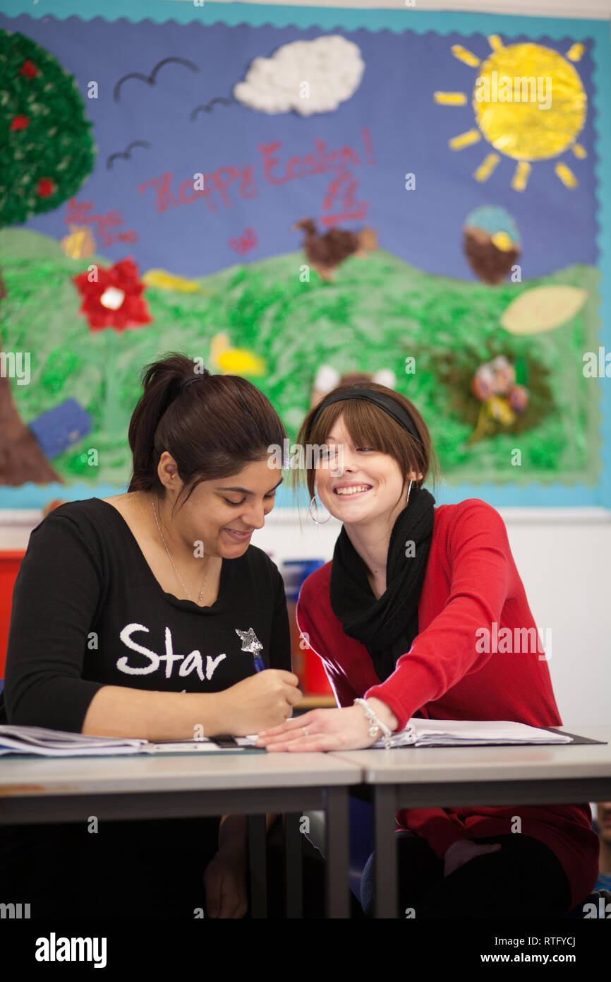 adults in a further education college working towards an apprenticeship in child care Stock Photo