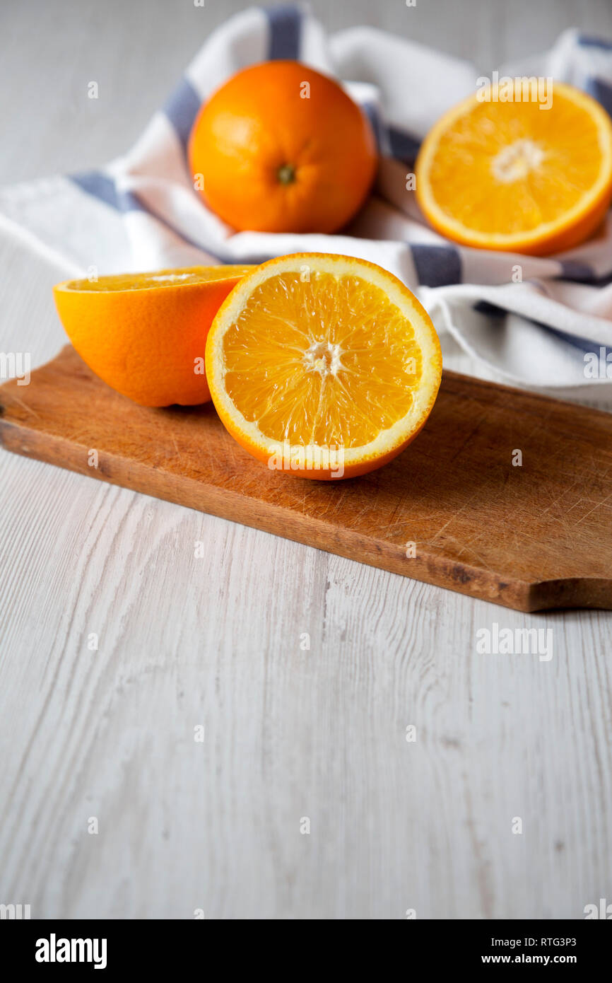 Halved and whole oranges, side view. Close-up. Space for text. Stock Photo