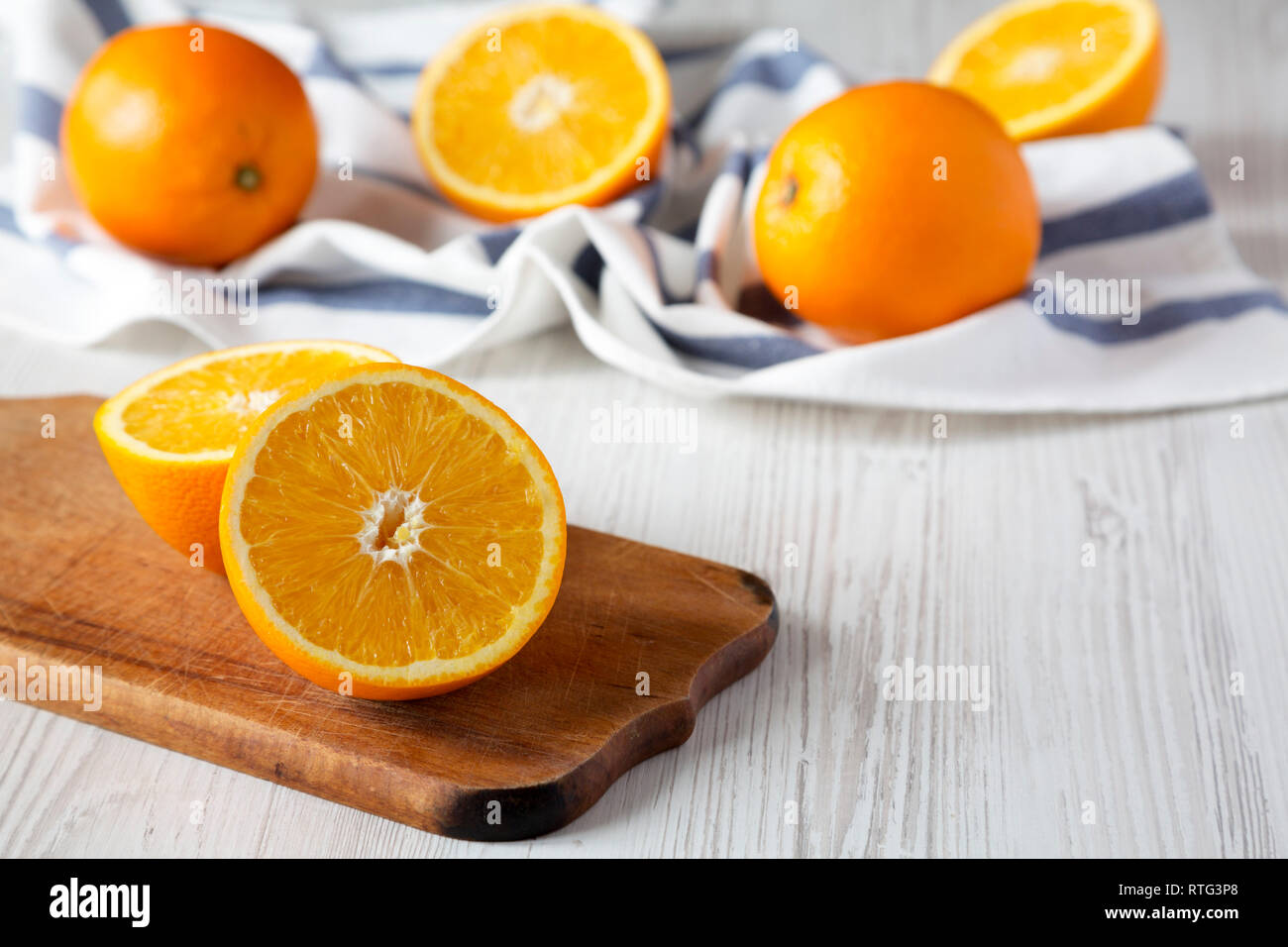 Halved and whole oranges, side view. Close-up. Copy space. Stock Photo