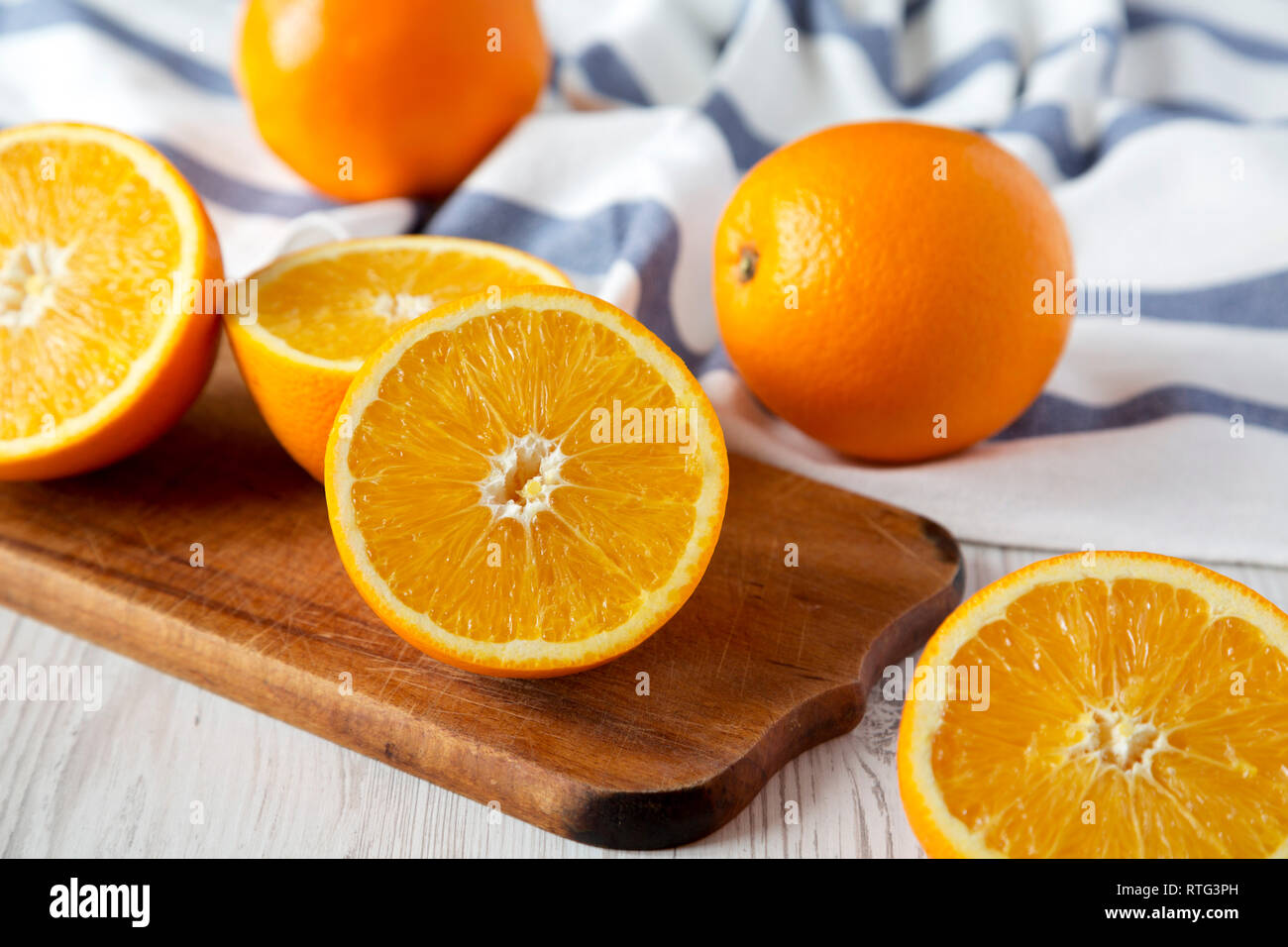Halved and whole oranges, side view. Closeup. Selective focus. Stock Photo