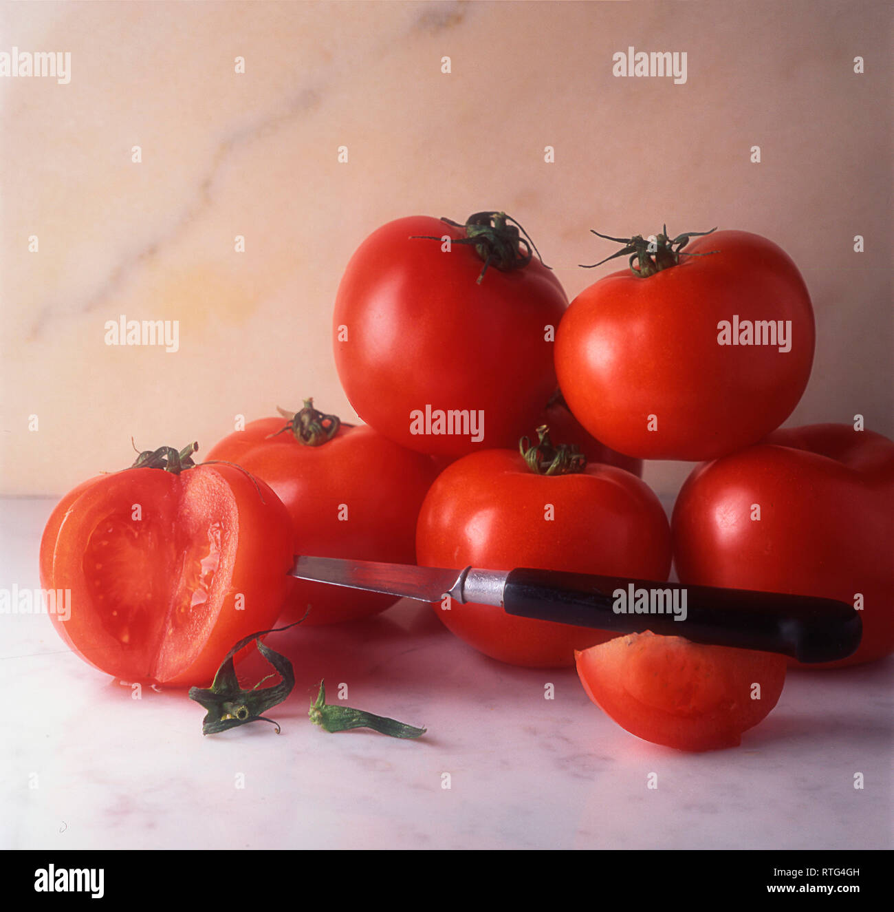 Tomatoes and a knife Stock Photo