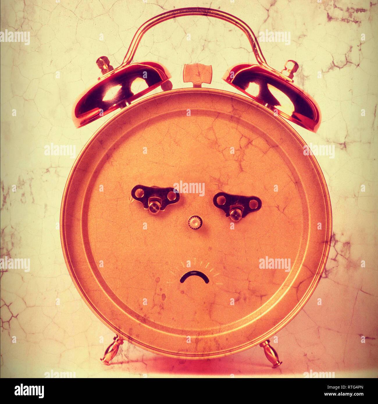 Back of an alarm clock in the shape of a frowning face Stock Photo Alamy