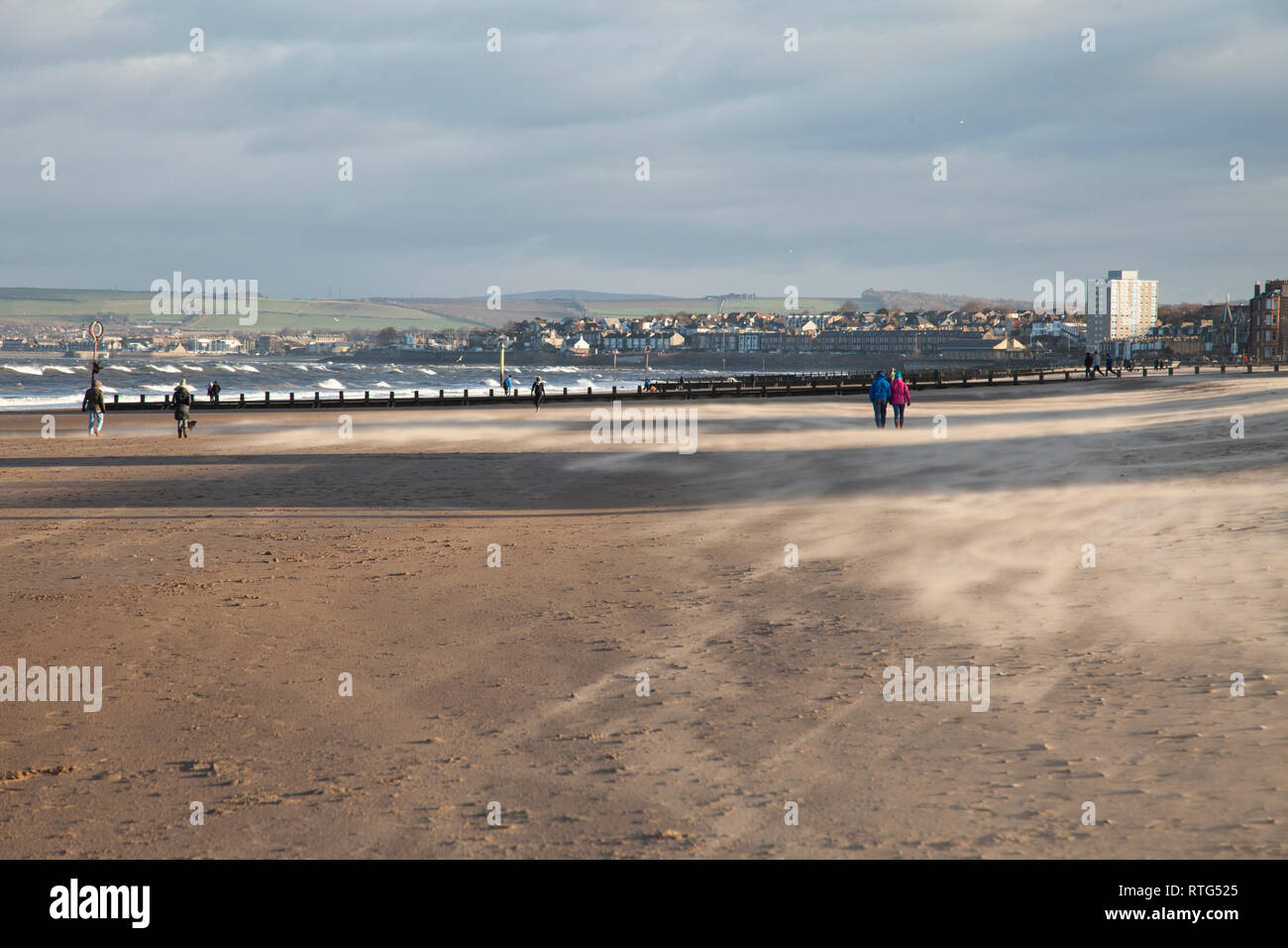 Sunny and very windy weather on a bright day on Portobello beach in