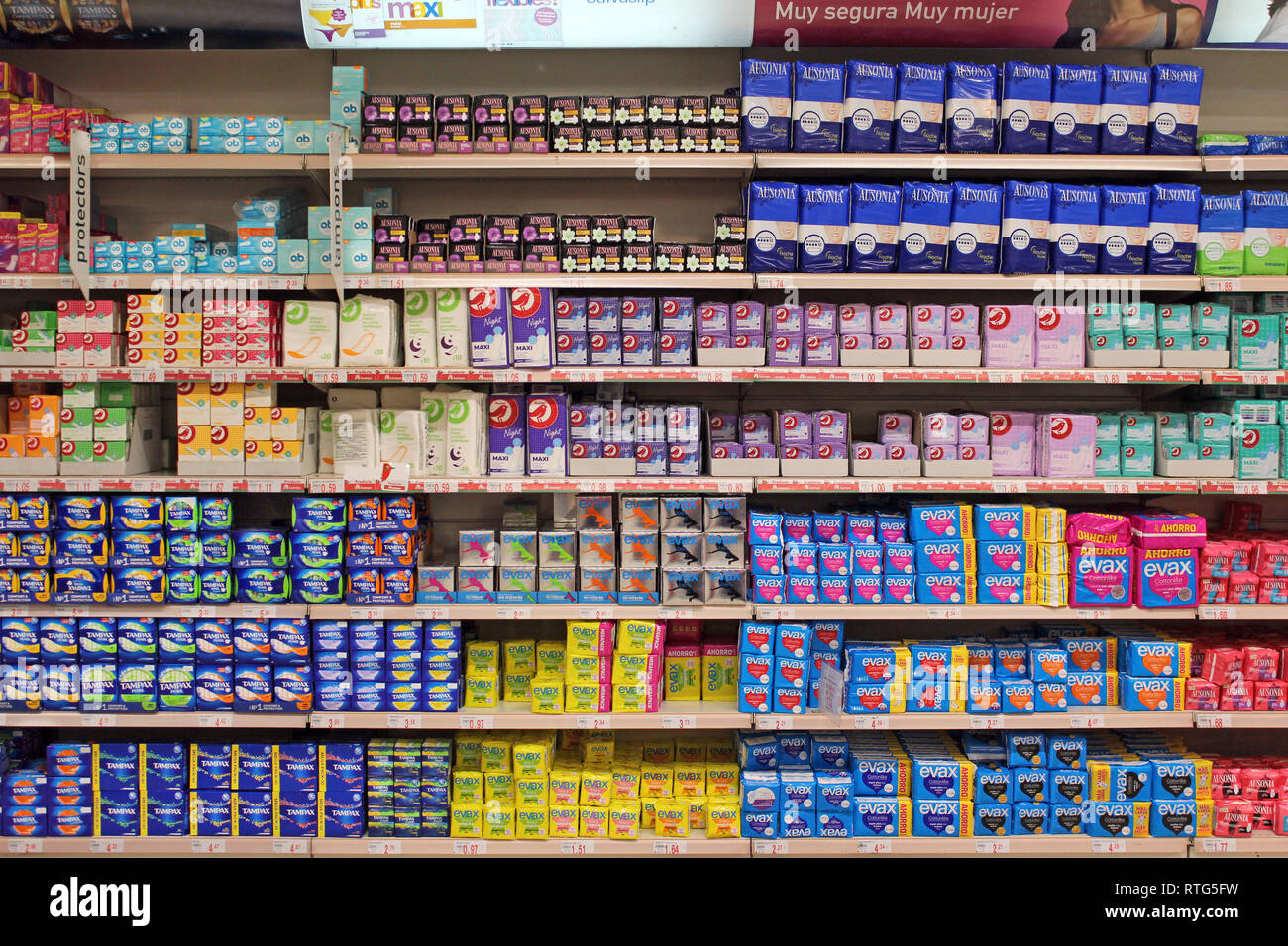 Stack of plastic disposable sanitary towels tampons and pads displayed on a supermarket Stock Photo