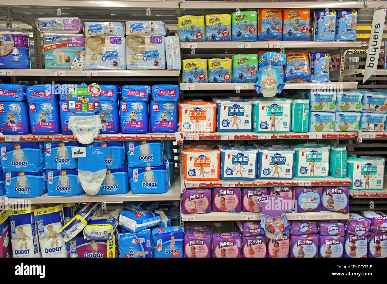 Stack of plastic disposable baby diapers displayed on a supermarket Stock Photo