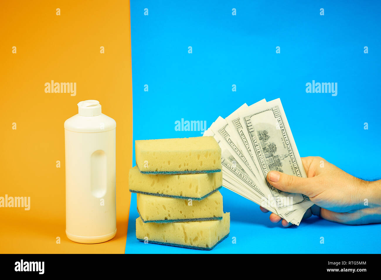 dishwashing detergent, sponges, money on colored background. homework