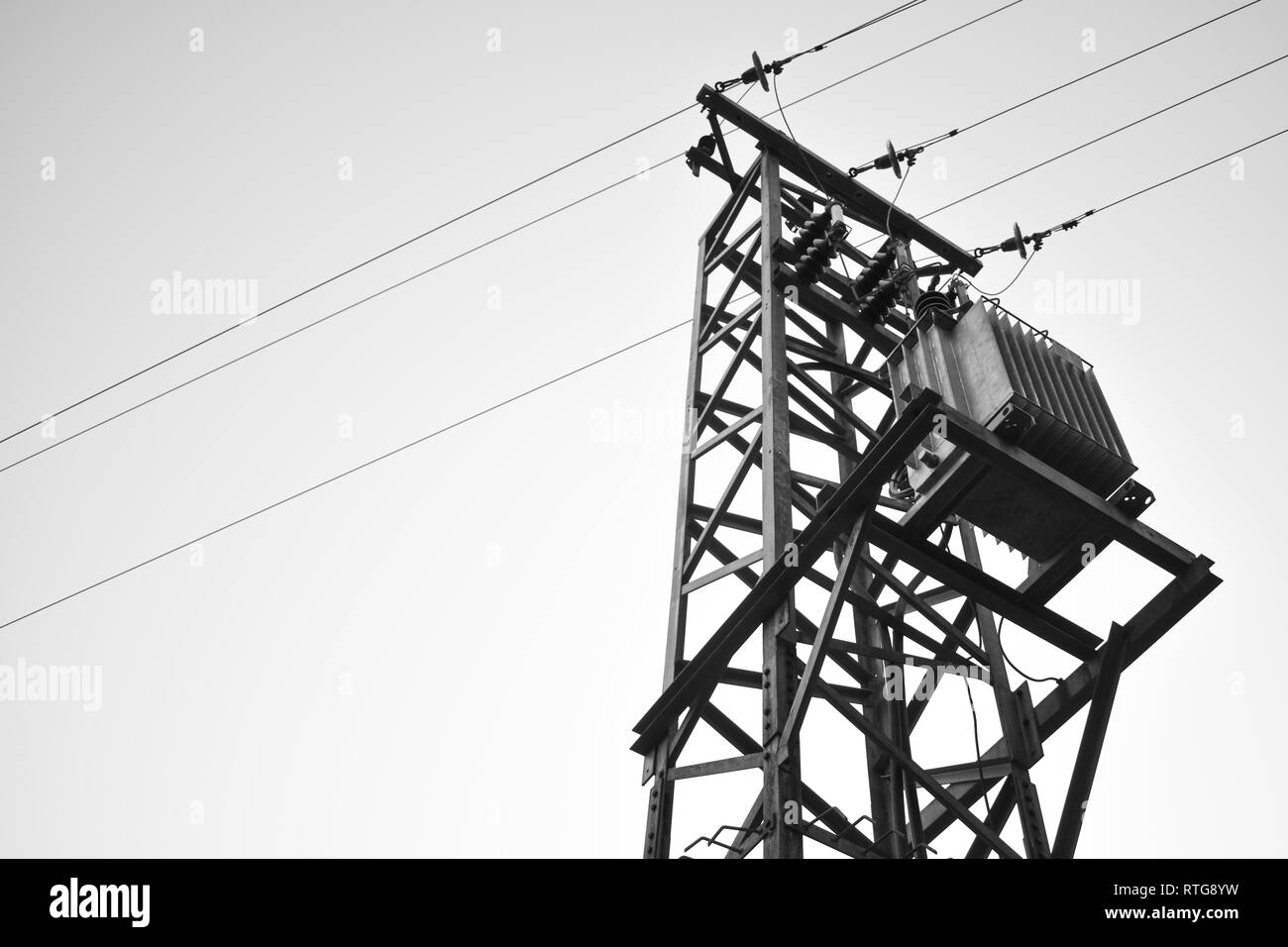 Utility pole with overhead power lines and transformer, black and white Stock Photo