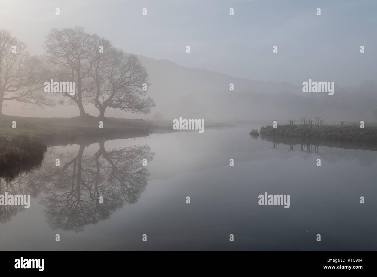 Early morning mist hanging over the River Brathay between Elterwater and Skelwith Bridge, Lake District, UK Stock Photo