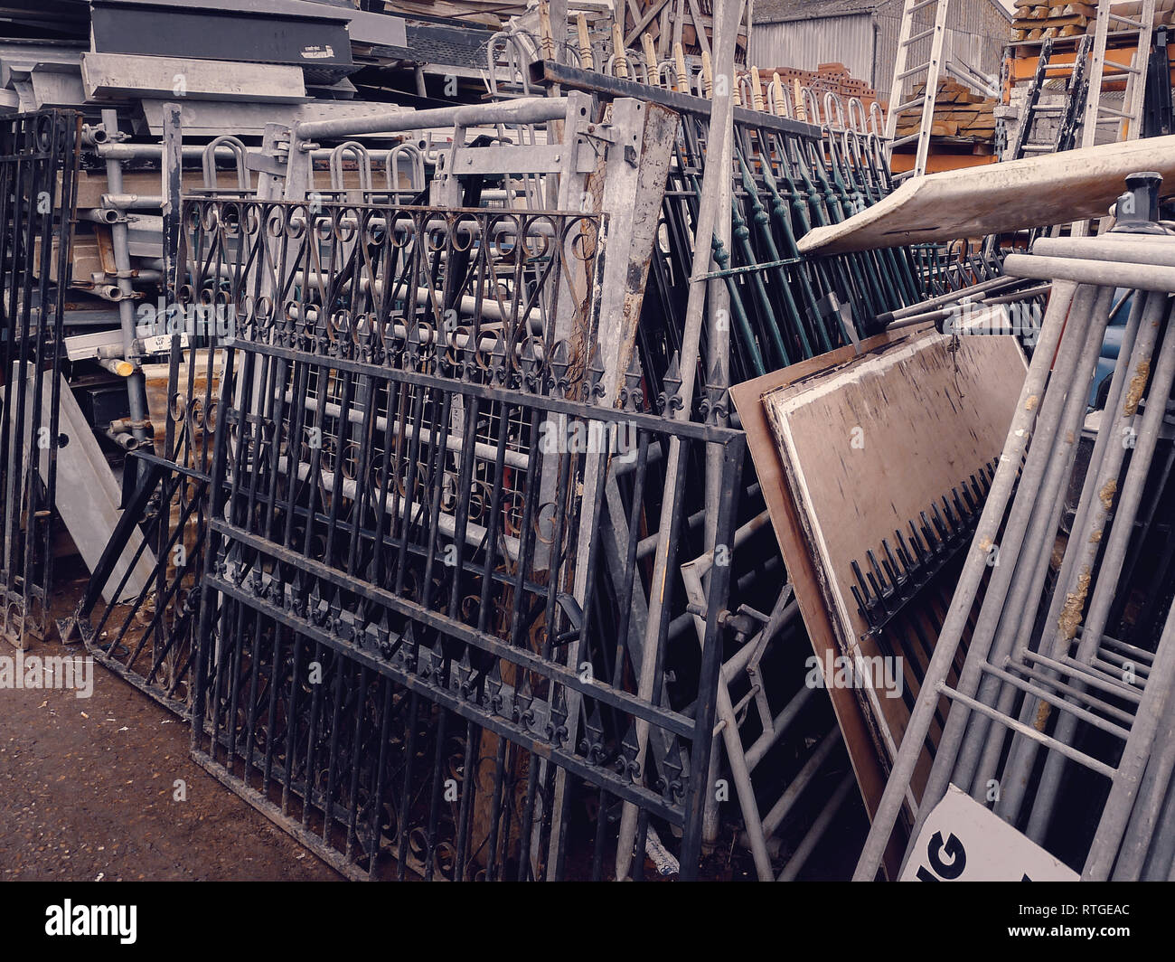 A collection of stacked wrought iron gates at a salvage yard in the UK