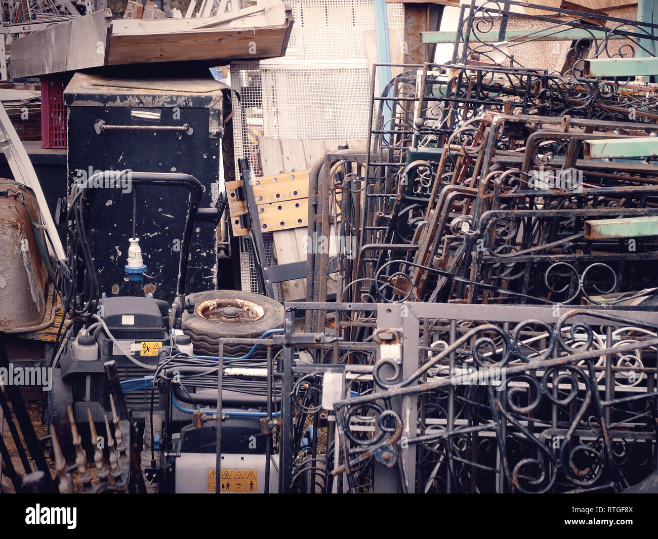 A collection of stacked wrought iron gates and other hardware at a