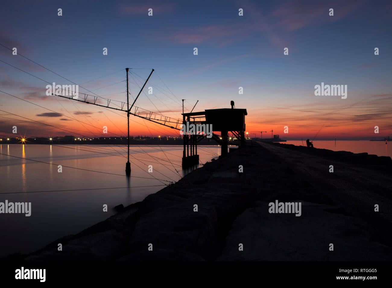 View of one trabucco, a typical old fishing machine built from wood at the sunset in Sottomarina of Chioggia Stock Photo