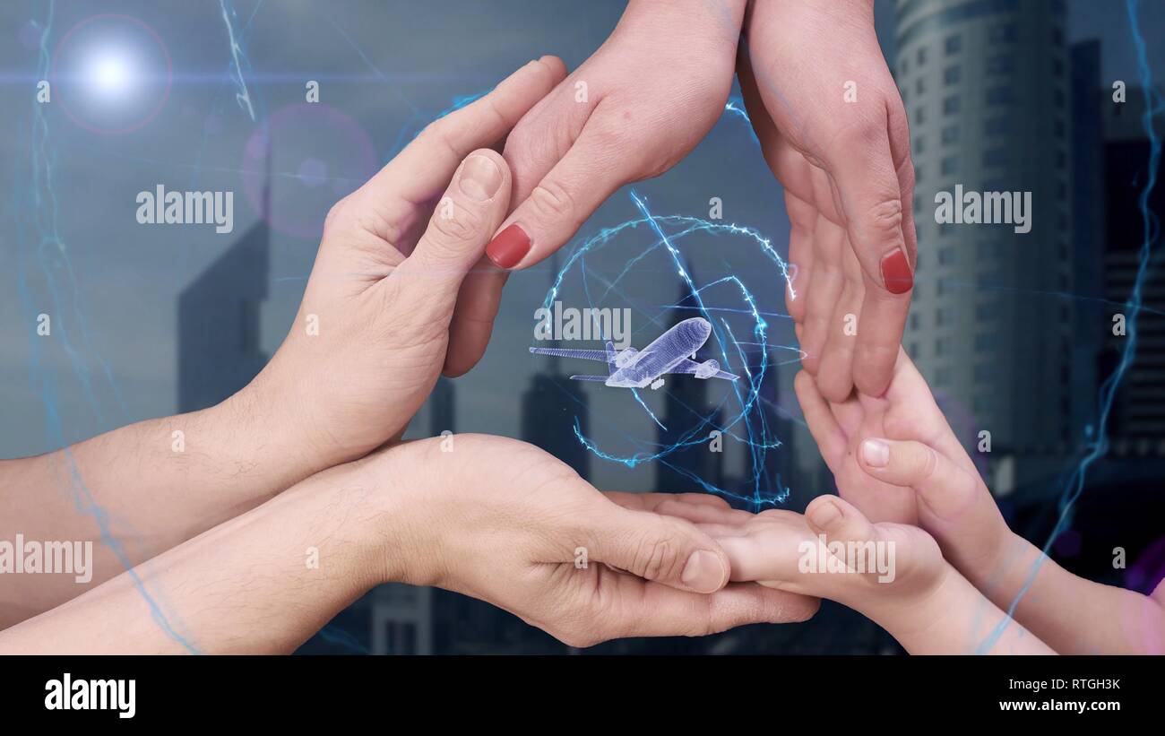 Men's, women's and children's hands show a hologram 3d plane Stock Photo