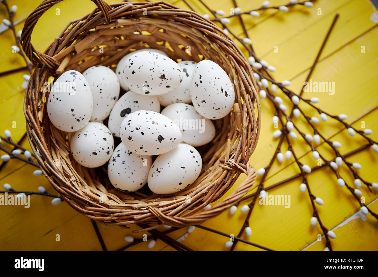 Whole chicken eggs in brown wicker basket. The concept of Easter Holidays Stock Photo