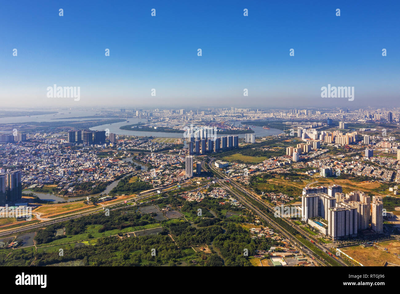 Top view aerial of Mai Chi Tho street. Ho Chi Minh City with development buildings, transportation, energy power infrastructure. Vietnam. Stock Photo