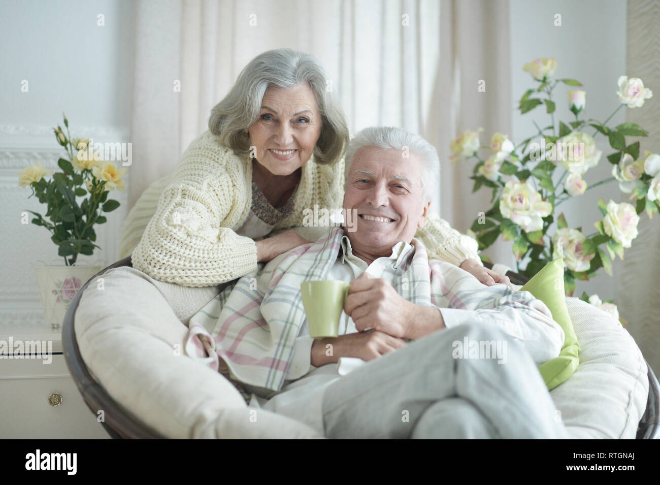 Portrait of two elderly people resting at home with tea Stock Photo