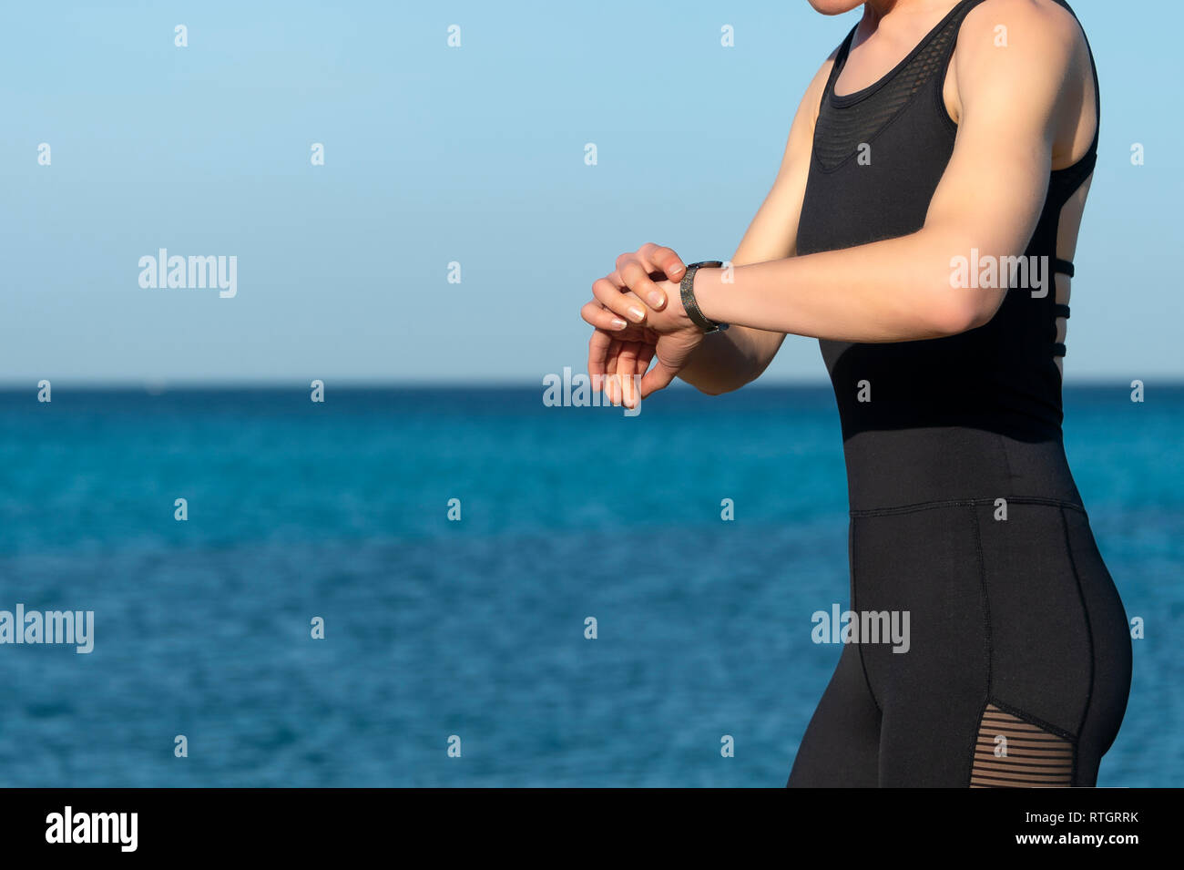 woman runner checking her fitbit, smart watch, close up Stock Photo