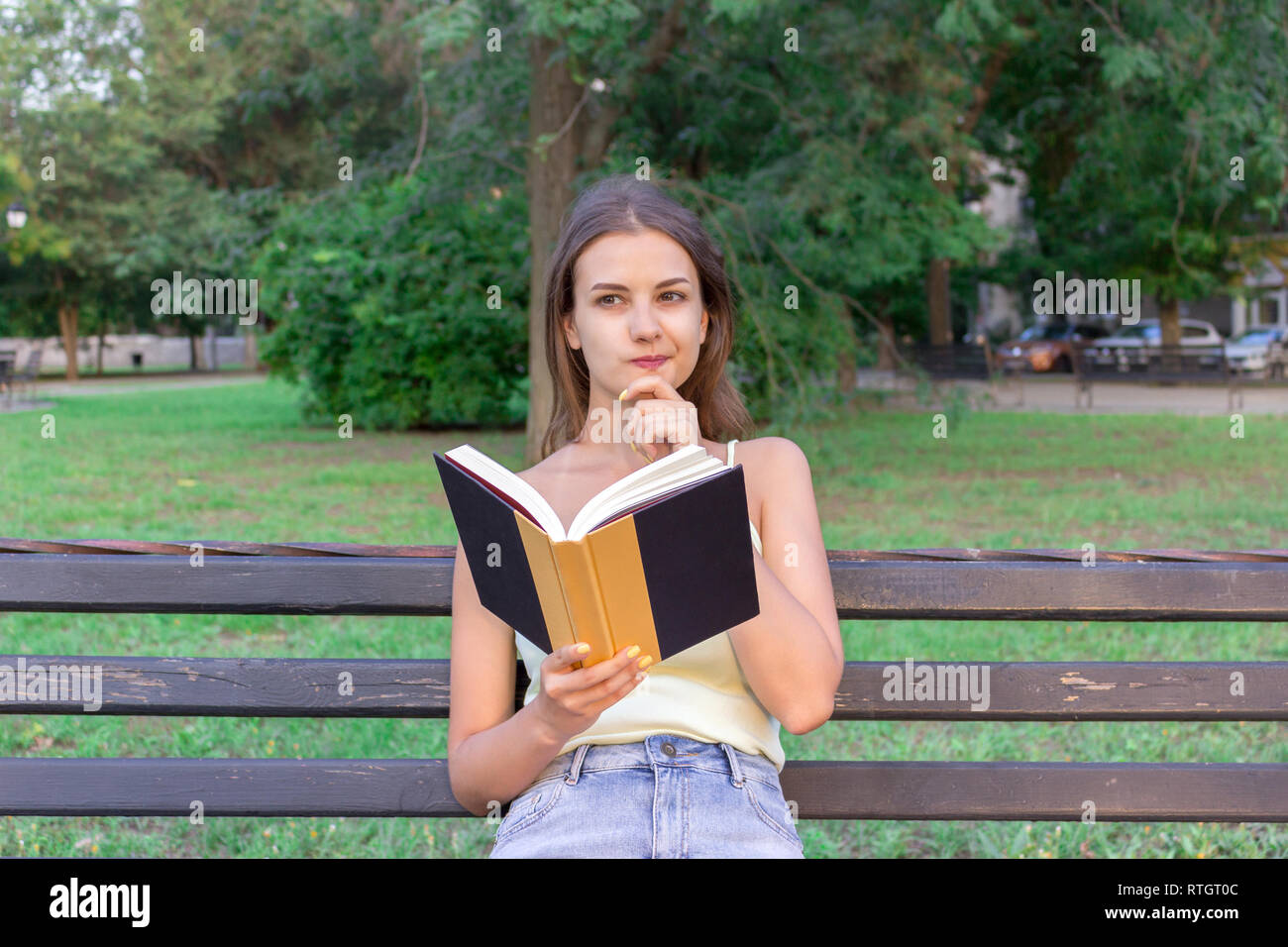 beautiful-woman-is-reading-a-book-and-thinking-about-something-on-the
