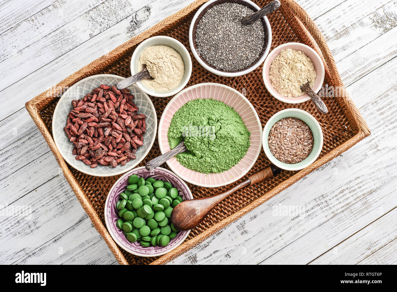 Different super foods in bowls on a rattan tray, top view Stock Photo