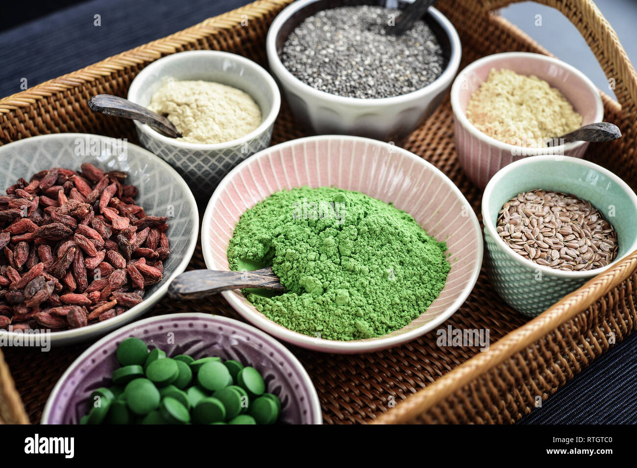 Different super foods in bowls on a rattan tray, top view Stock Photo