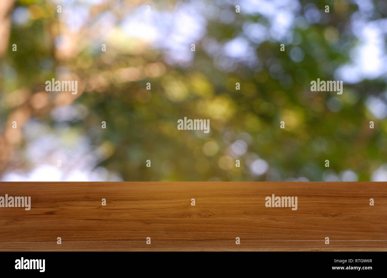 Empty Wooden Table In Front Of Abstract Blurred Green Of Garden And Nature Light Background For