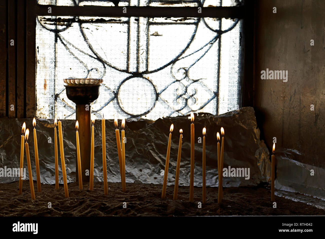 Votive candles in sand in a greek orthodox church, Athens, Greece Stock