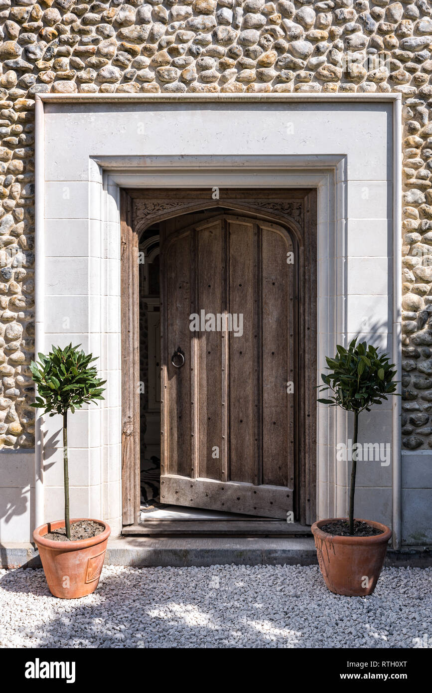 Reclaimed 15th century monastery door and limestone surround to restored medieval house Stock Photo