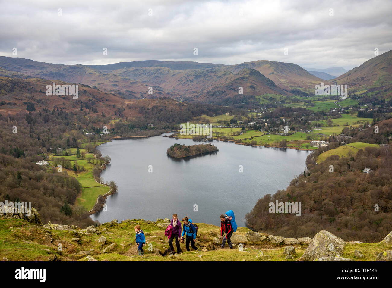 People hiking on Loughrigg Fell with Lake Grasmere behind them,Grasmere,Lake District national