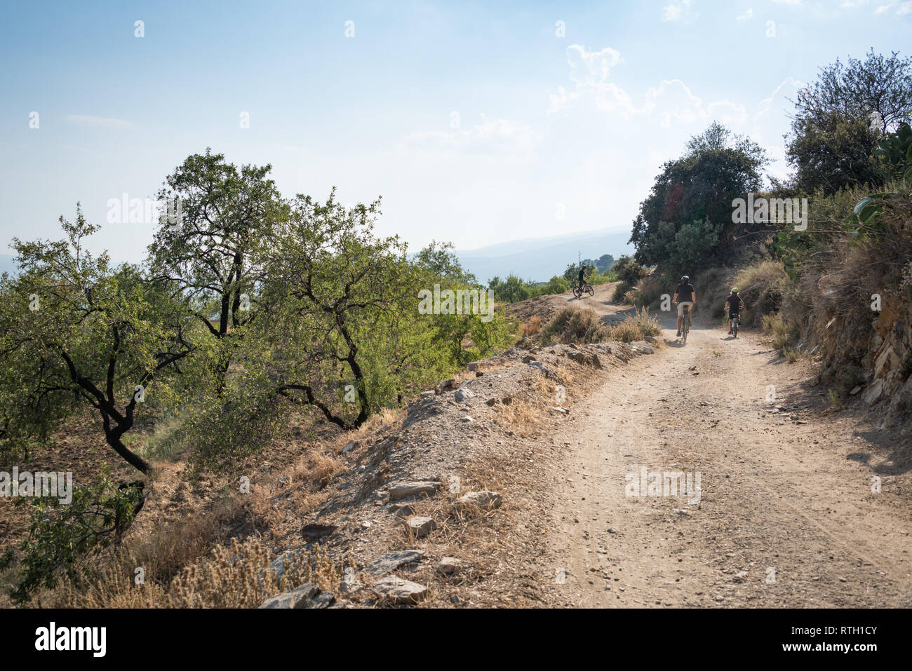 Cycling along a dirt track near Jubar in the Alpujarras region of Andalucia, Spain Stock Photo