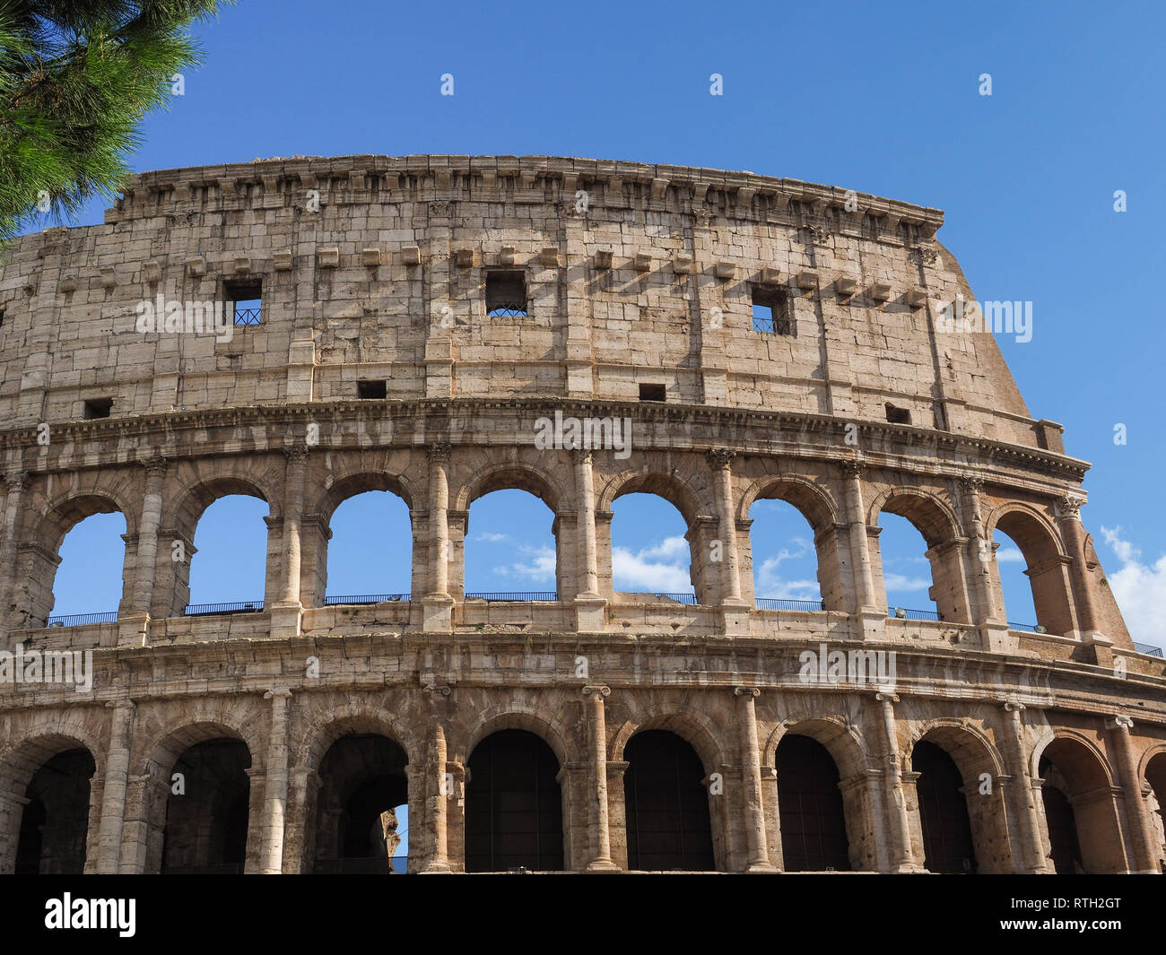 Eternal Italian city Rome and famous Amphitheater Colosseum or Colosseo. Original facade of Arena Flavio still an iconic symbol of Roman Empire. Stock Photo
