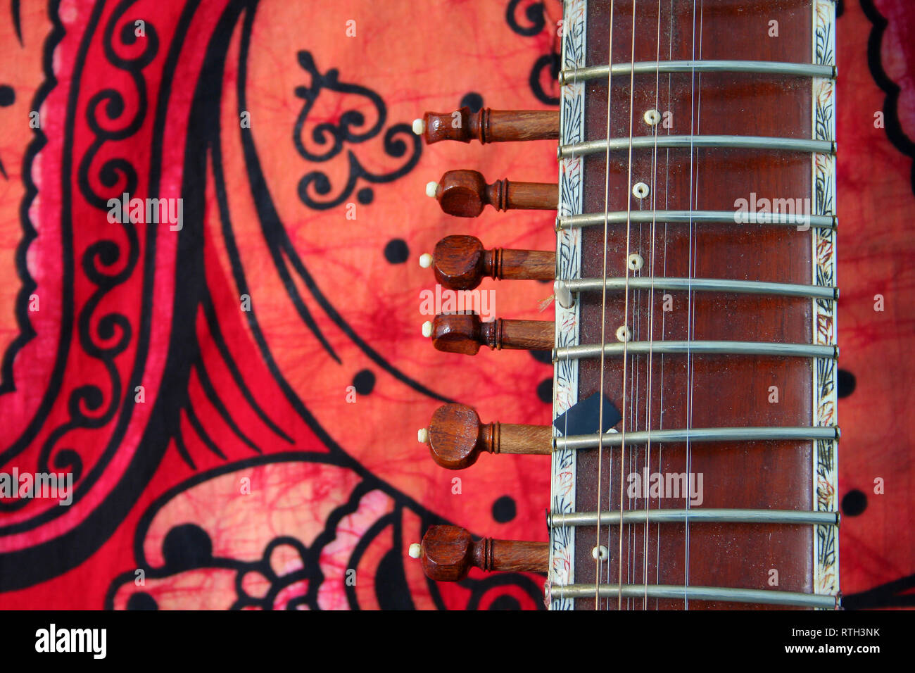 old sitar on red background ancient indian instrument Stock Photo Alamy